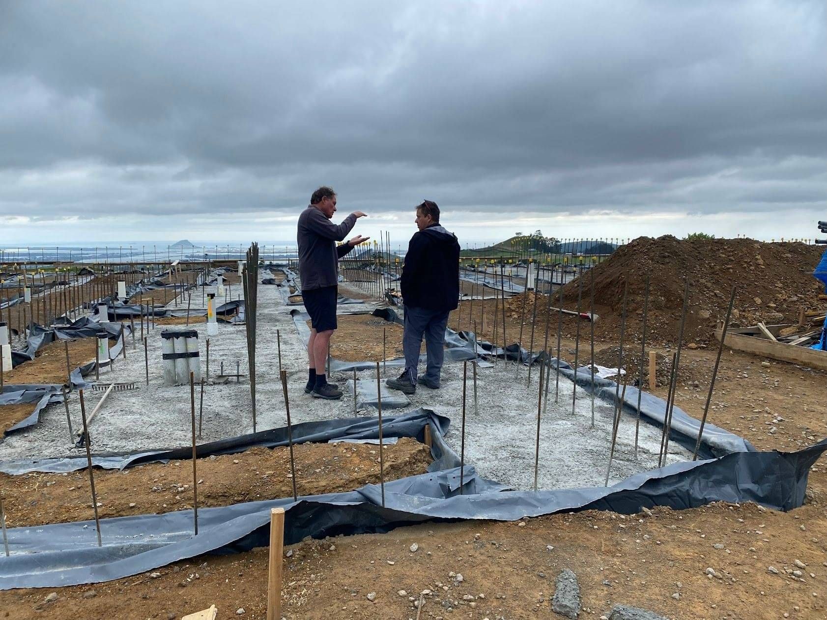 Electricians on a building site of a new build, planning electrics