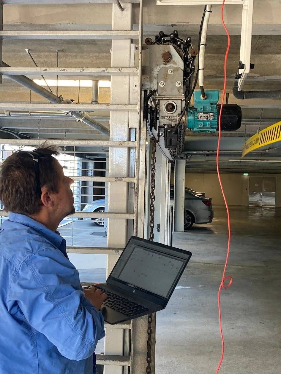 Electrician assessing roller door automation electrics