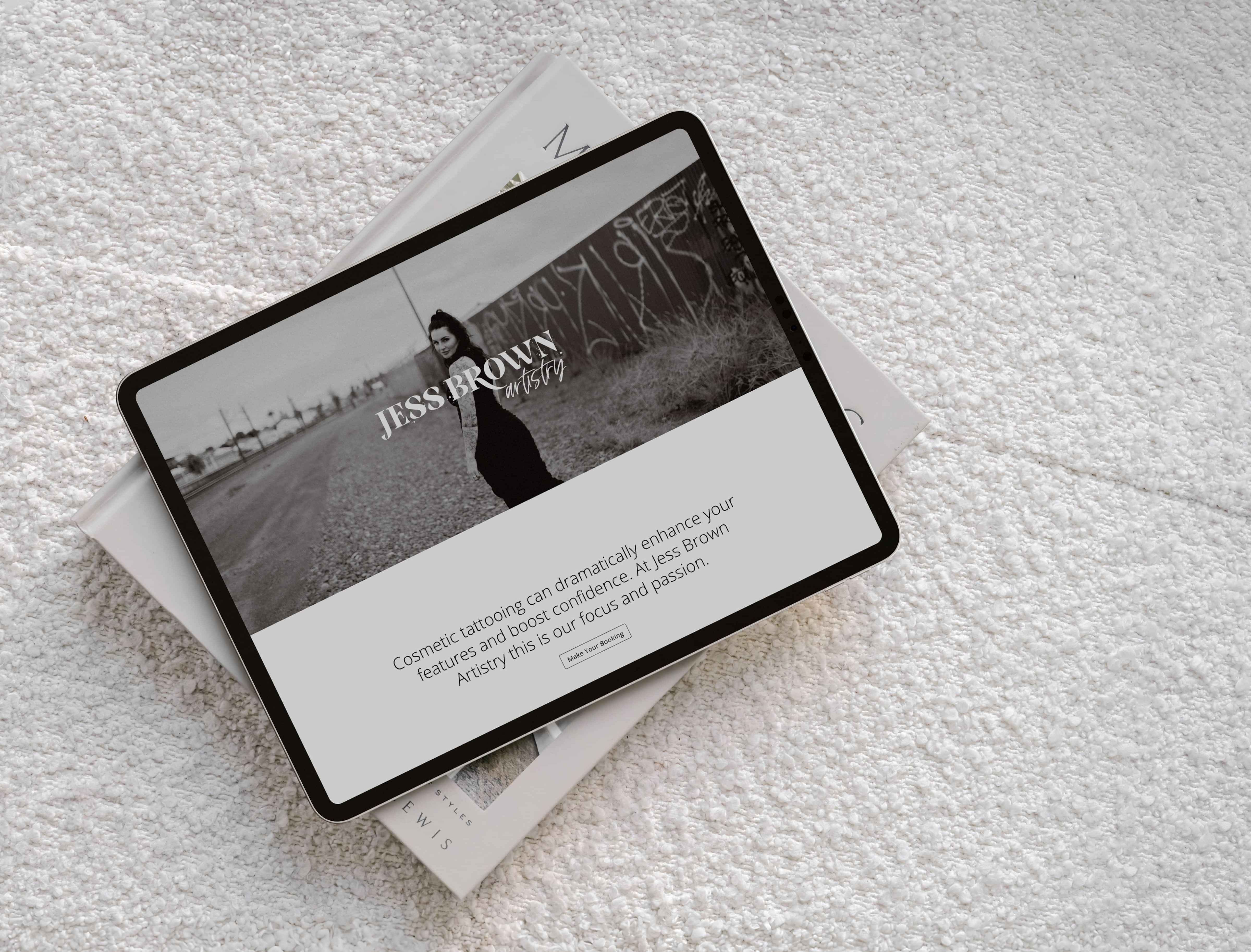 Image of ipad mockup with Jess Brown’s website on a white couch. By Creative Box