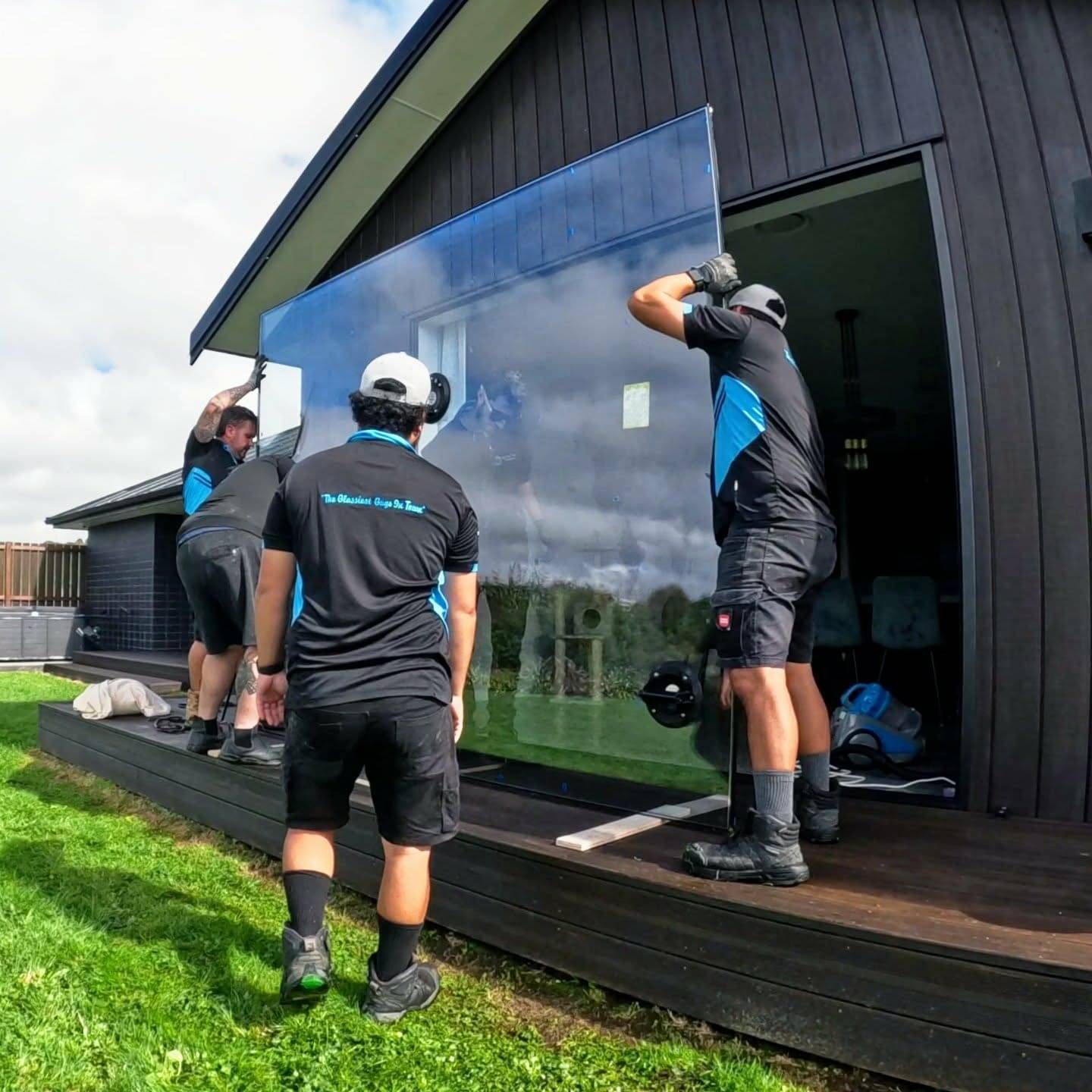 The team at The Glass Guys installing a large glass panel