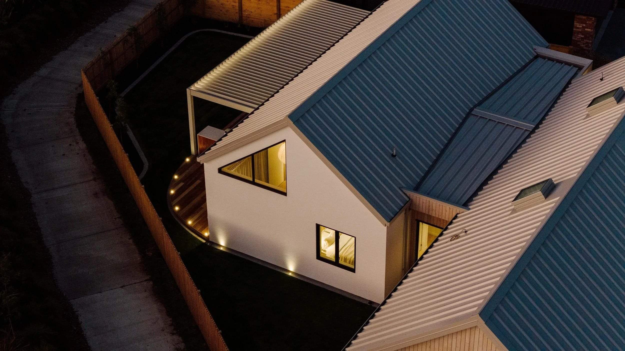 View from above of a home light up at night