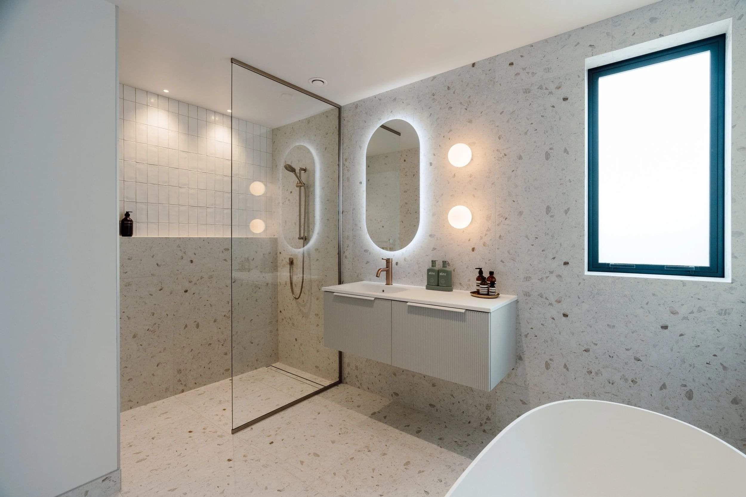 Modern floor to ceiling tiled bathroom