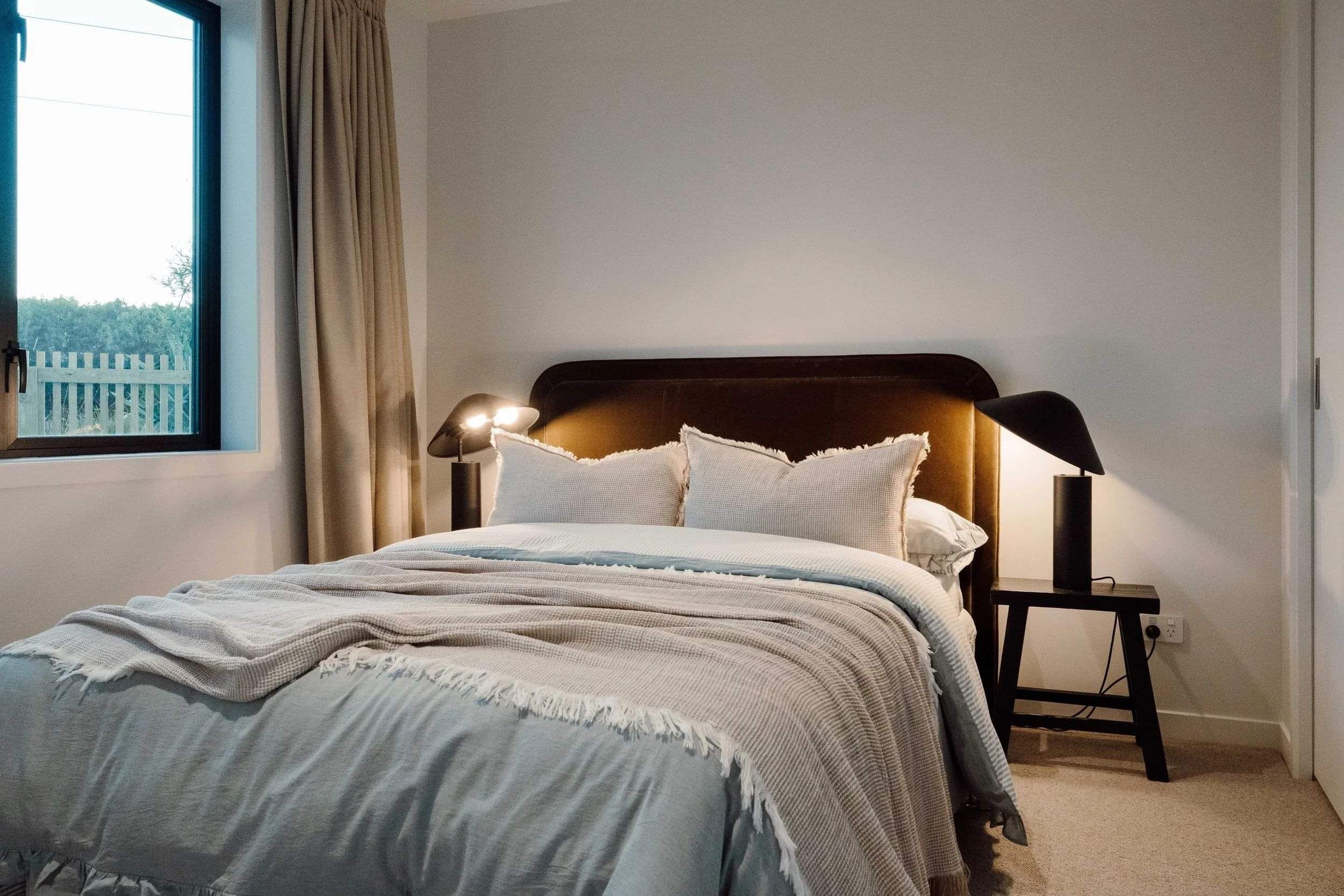 Modern bedroom with side tables and lamps