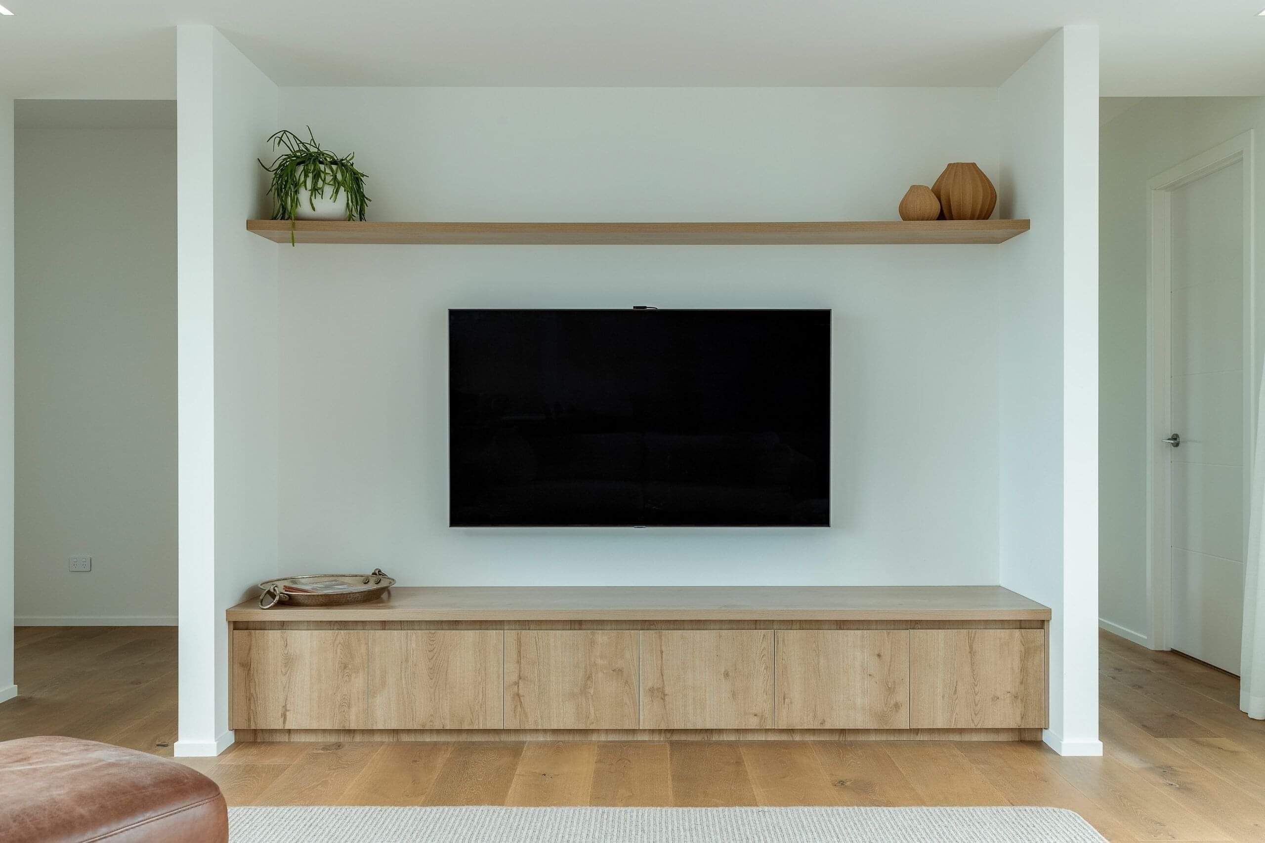 Custom cabinetry in the living room below the TV