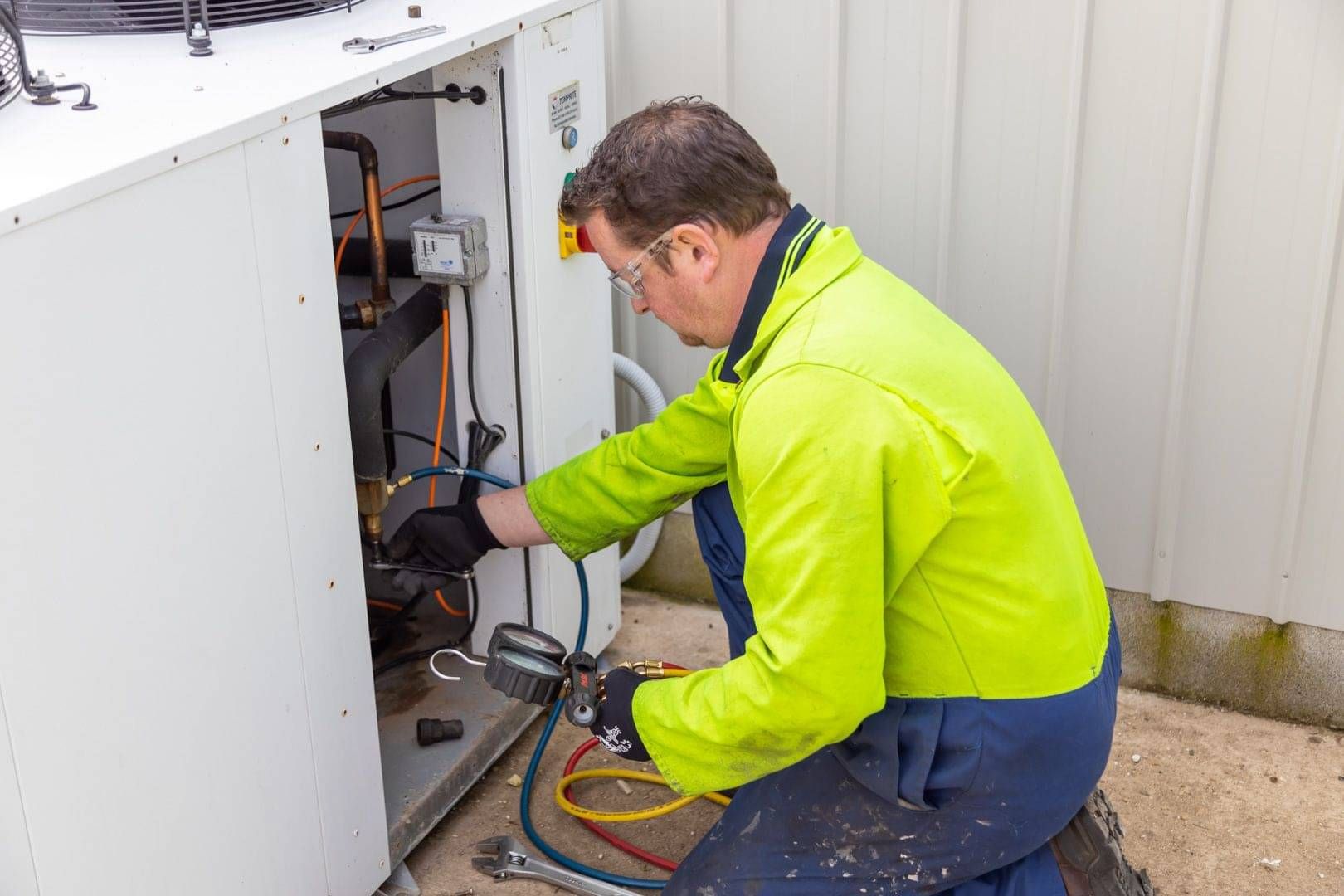 Technician repairing commercial refrigeration equipment