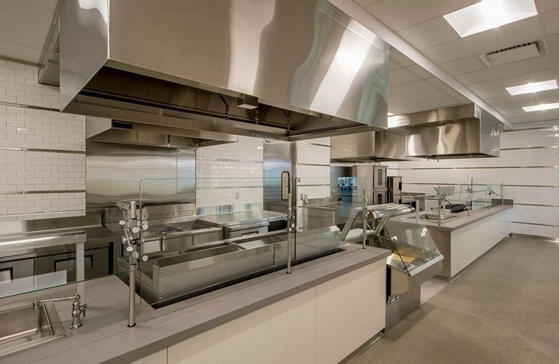 Stainless steel extraction canopy in a commercial kitchen