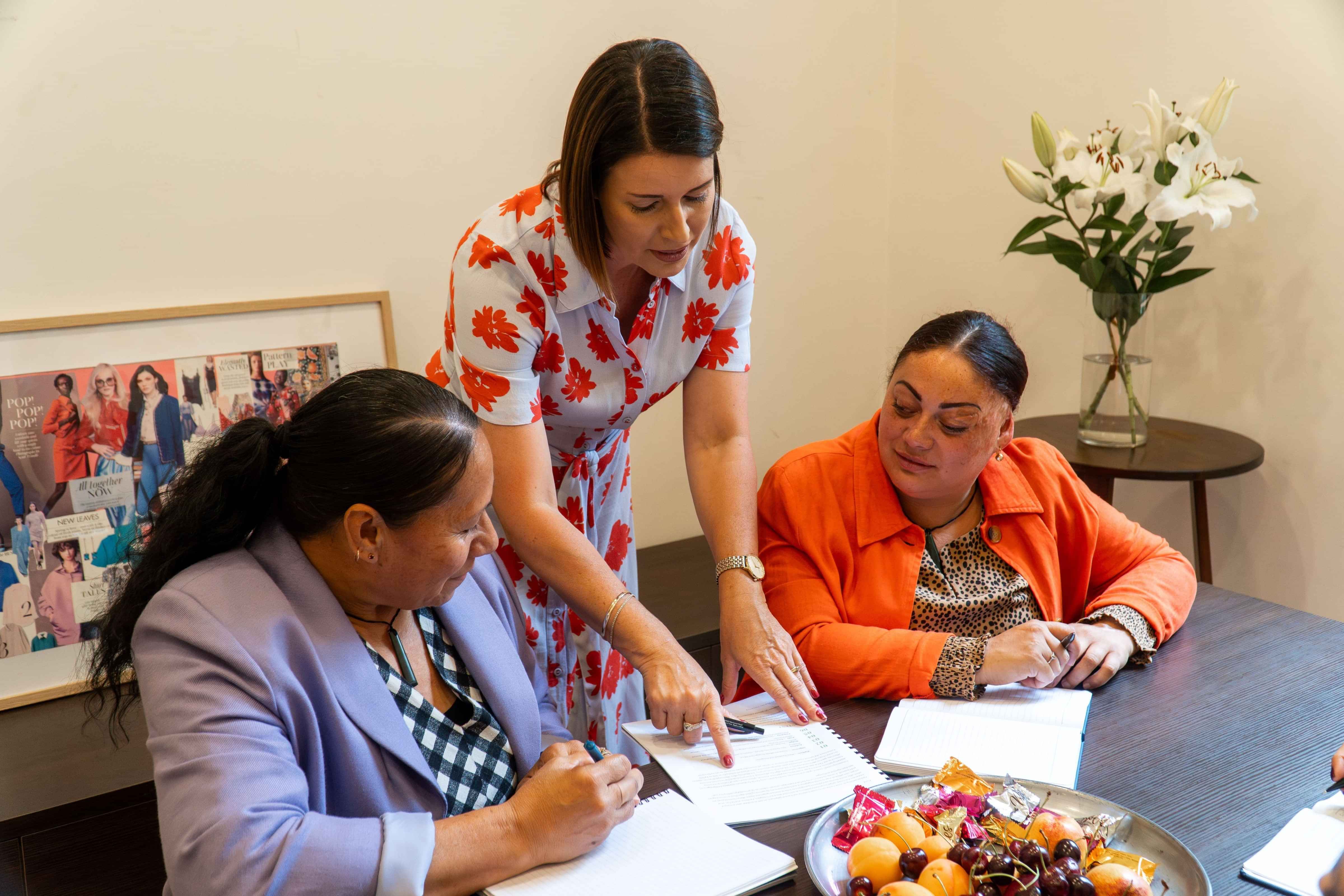 Dress for Success ladies going through documents in a careers centre appointment