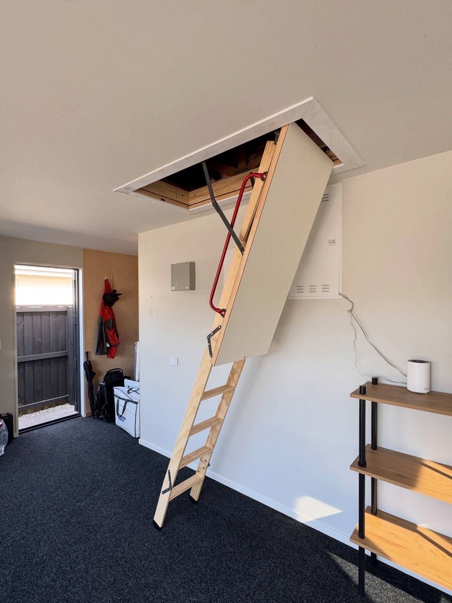 Fold down timber attic ladder with white ceiling trim