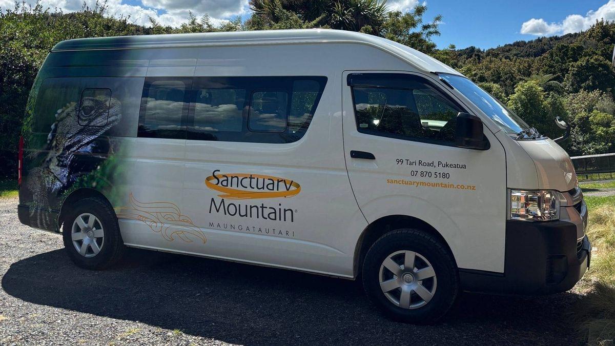 The Sanctuary Mountain Maungatautari shuttle van parked beside the bush