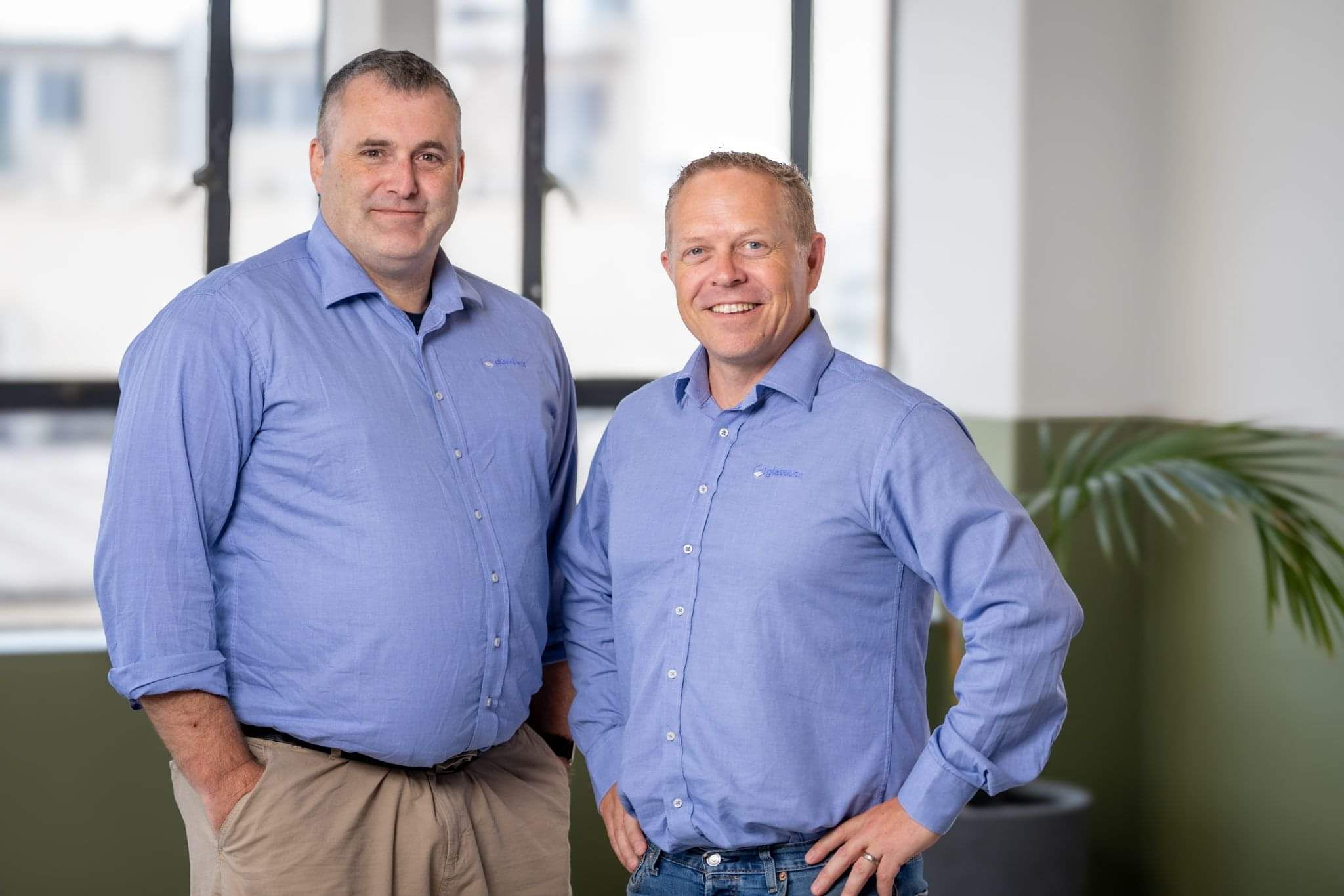 Glassbox founders standing together at the company's Hamilton office