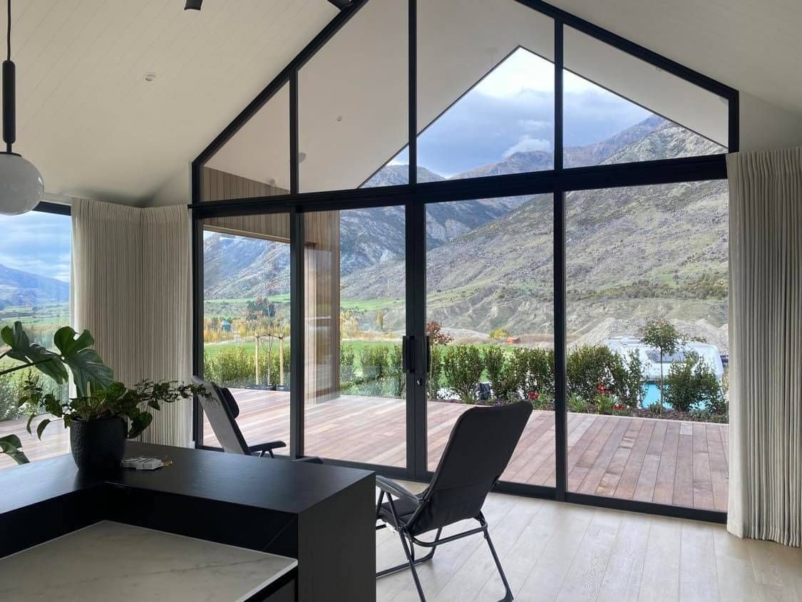 Sheer curtain on floor to ceiling window with mountain and deck view, Quality Curtains Tauranga