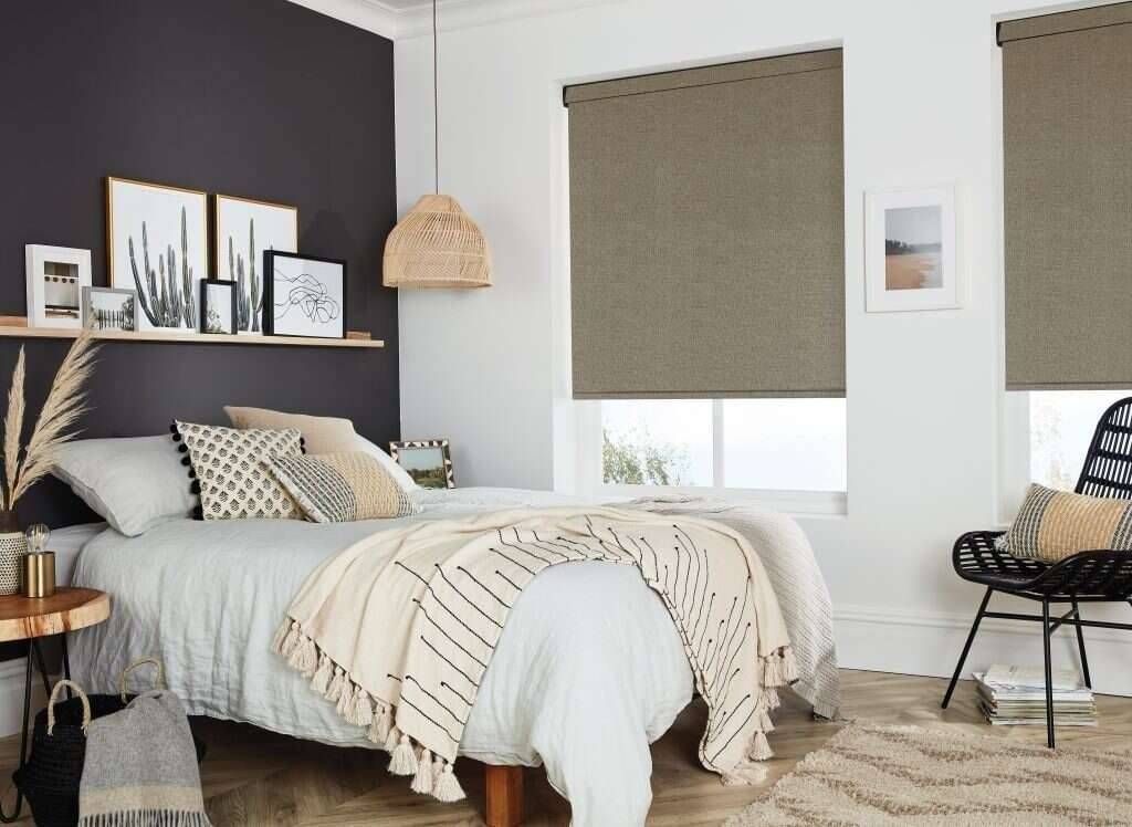 Custom roller blinds installed in a modern bedroom