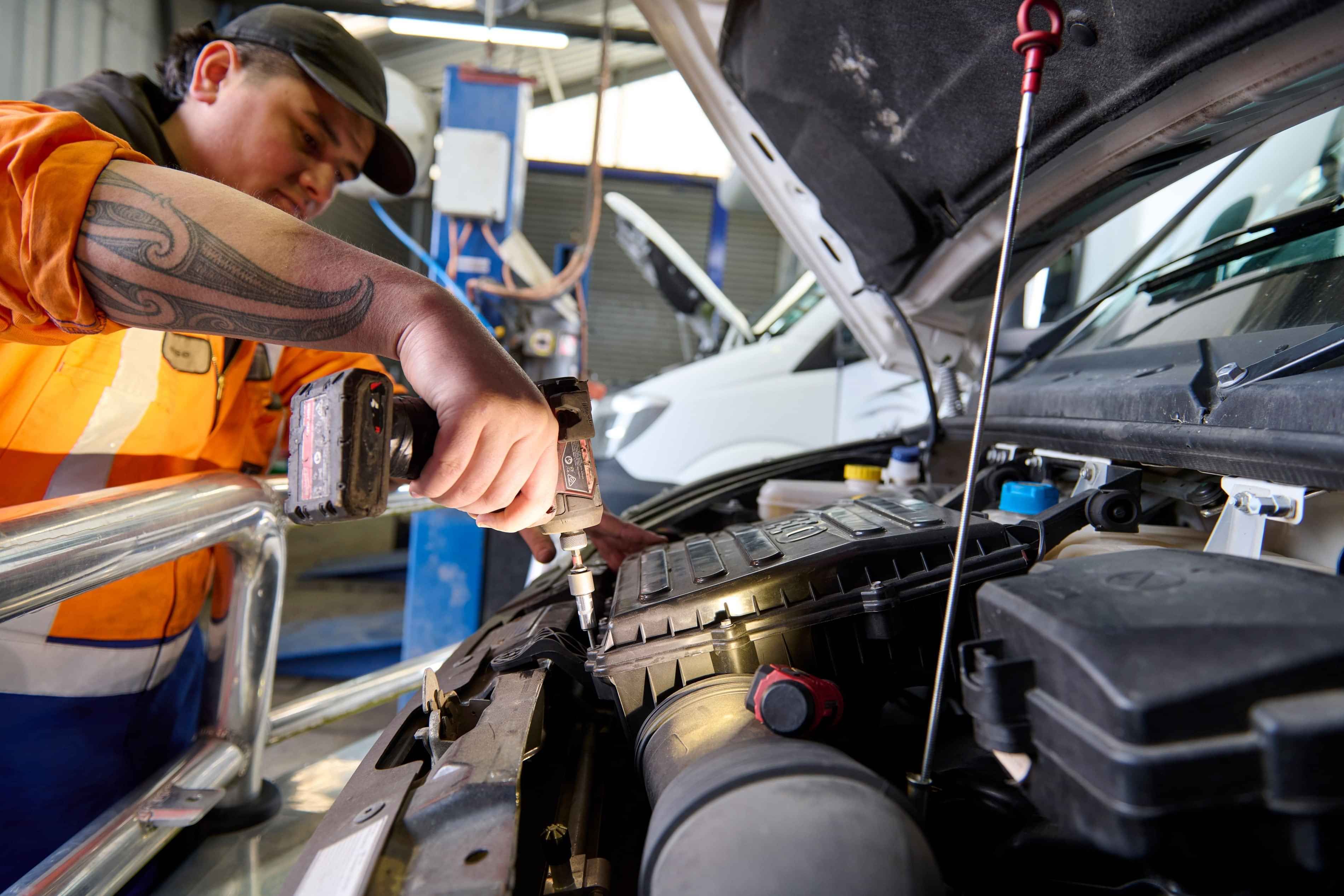 Diesel mechanic servicing a motorhome at Taupo workshop, Dudley Mechanical & Parts.