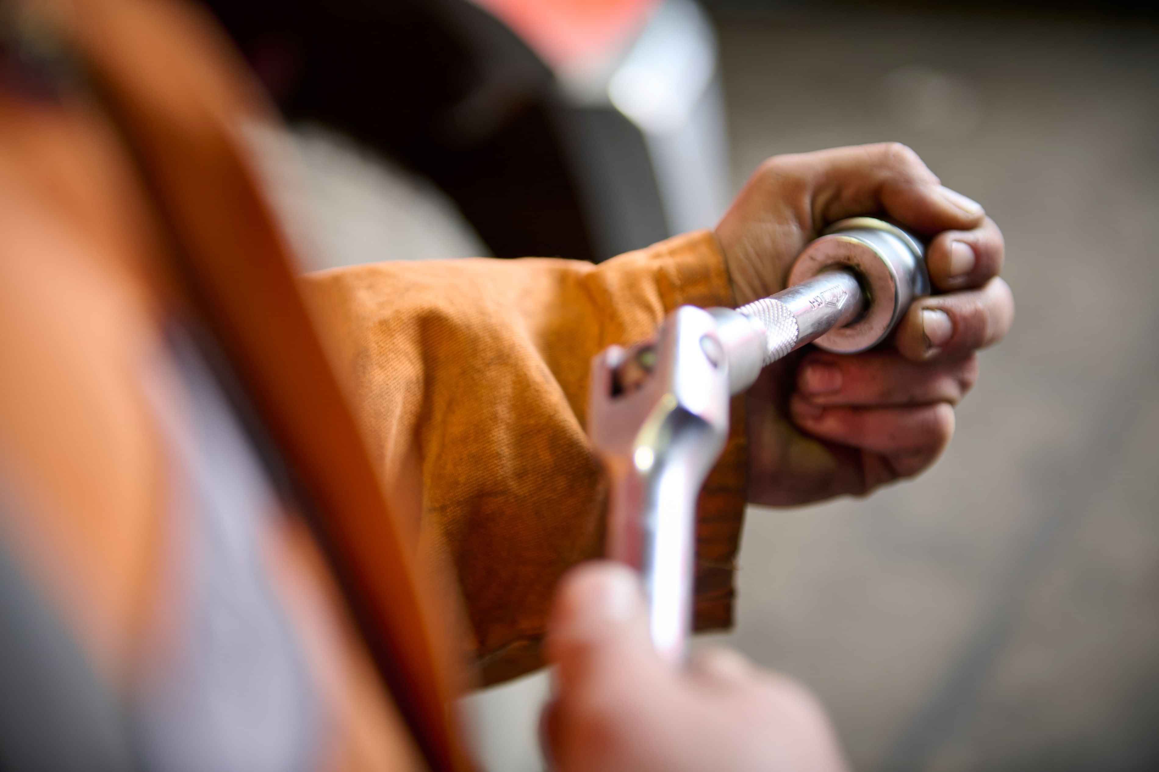 Diesel mechanic working with a tool at Dudley Mechanical & Part's Taupo workshop