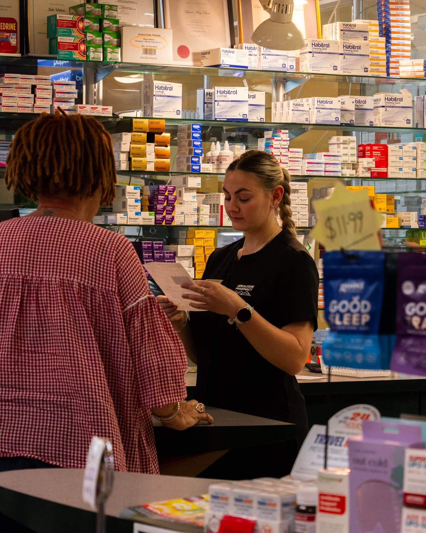 A Pharmasist explains a prescription to a patient