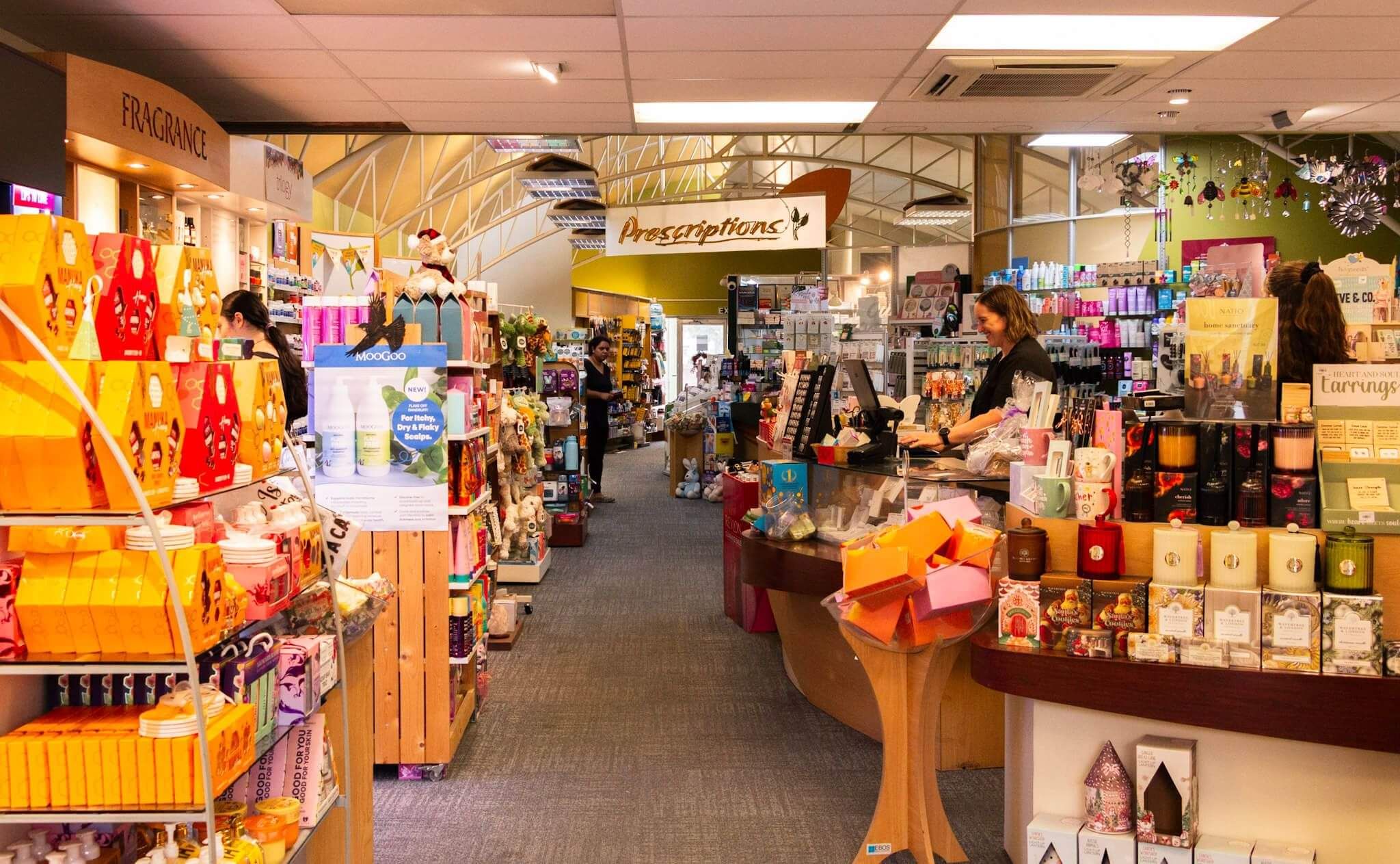 Veiw through pharmacy shop with the counter to the right and displays in the left
