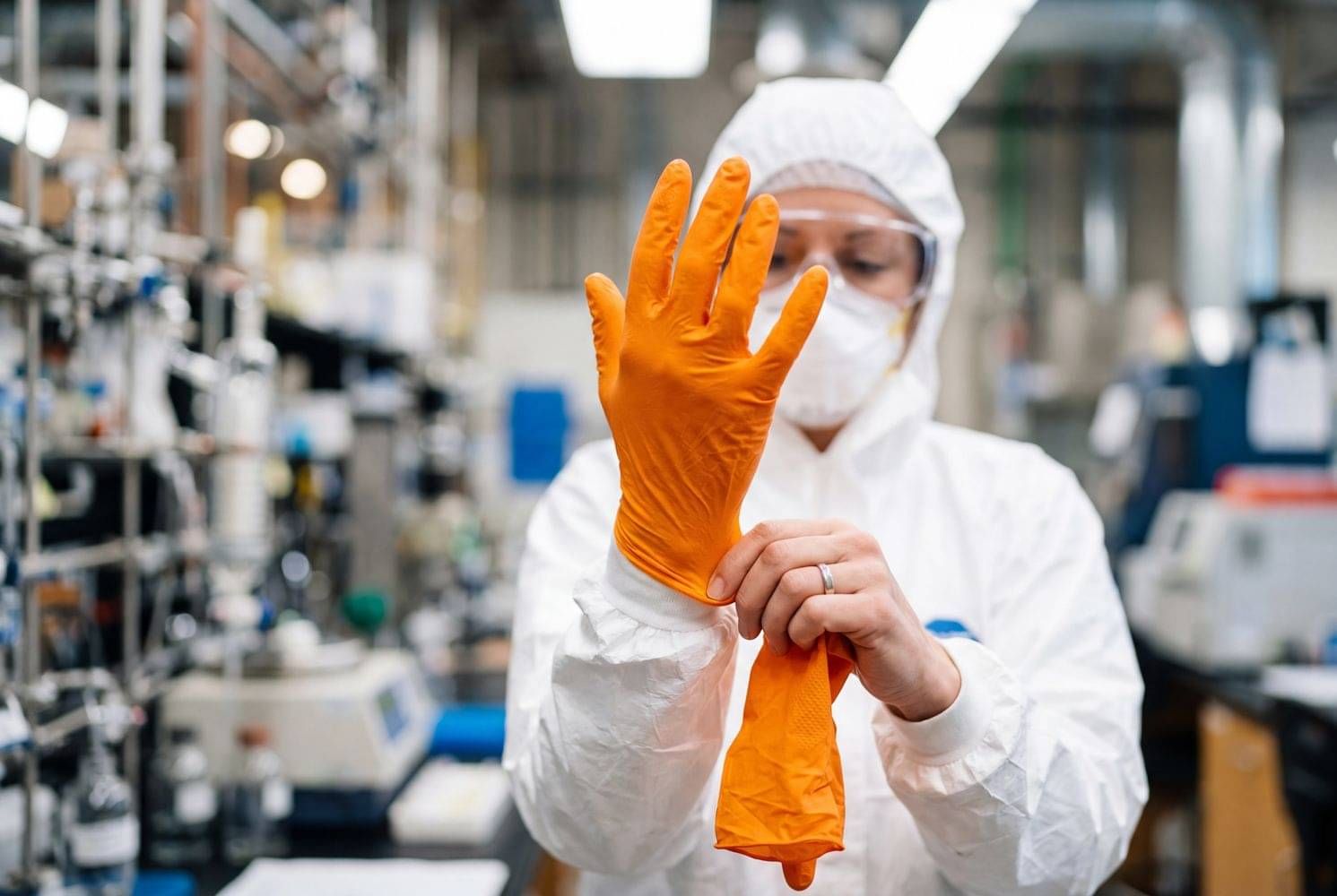 Worker in protective clothing using CheckSafe to manage workplace competency