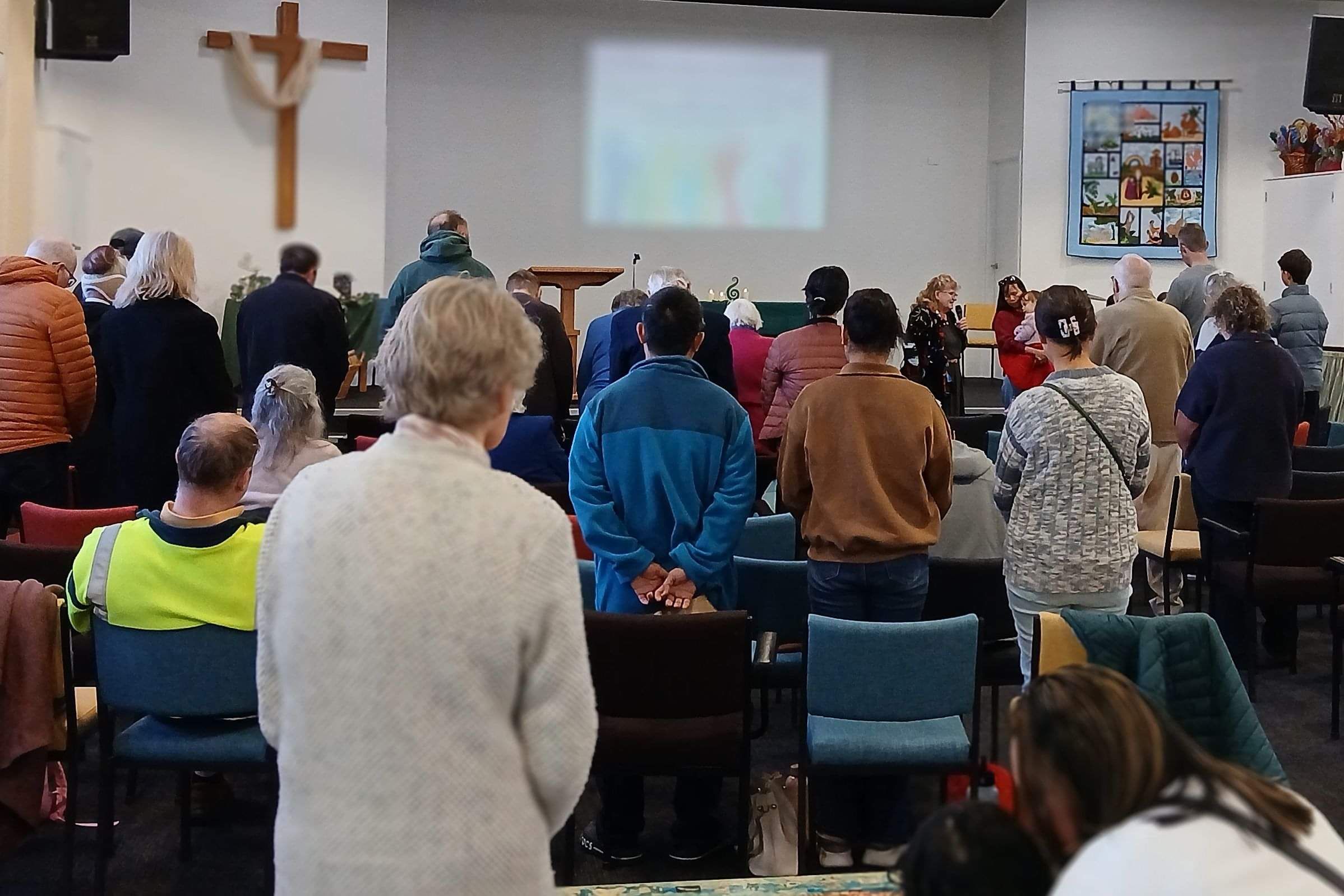 Image of church worship service in Hamilton with people of many different ethnicities.