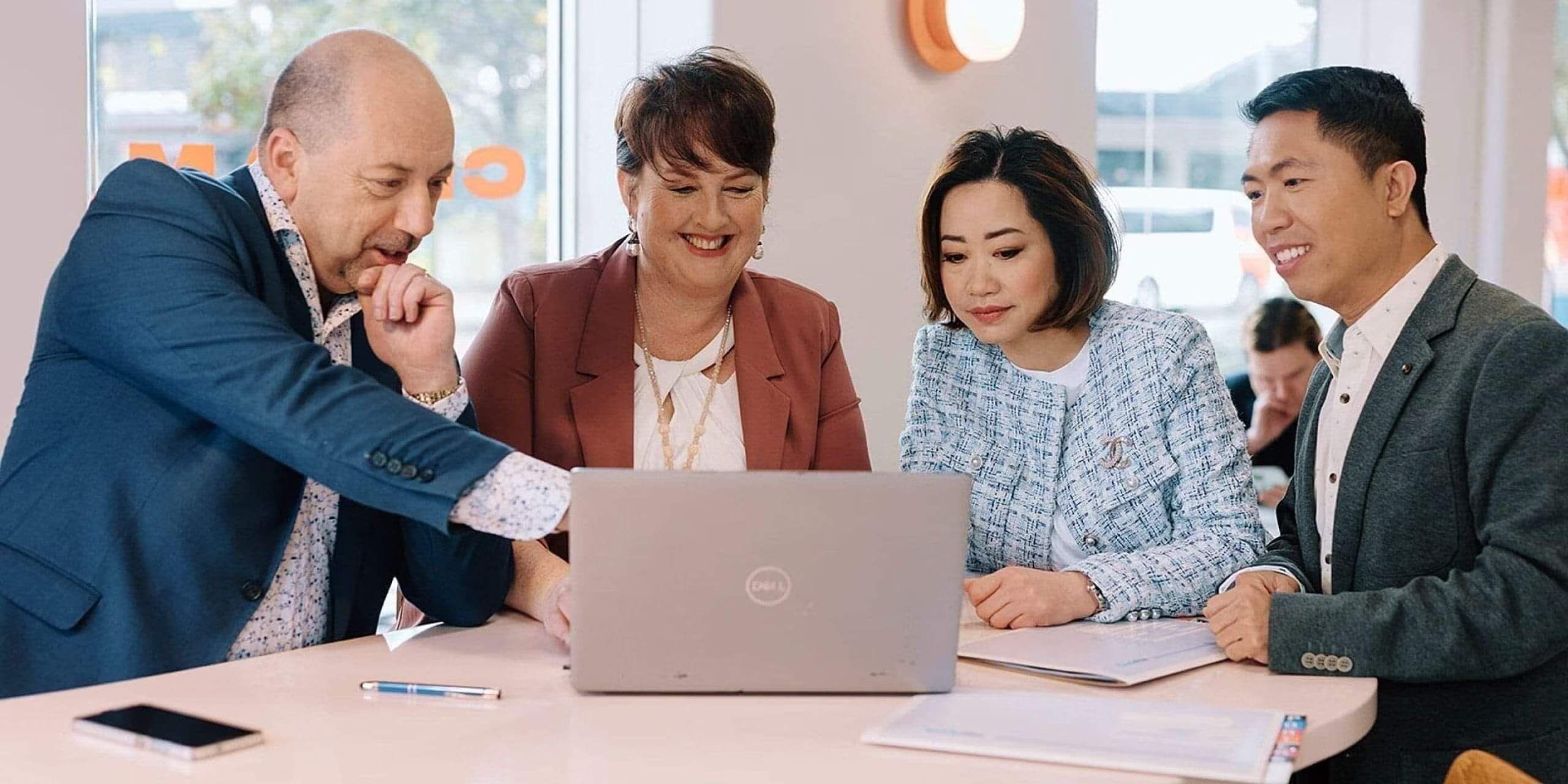 Three Neazor Brady advisers working together at a laptop