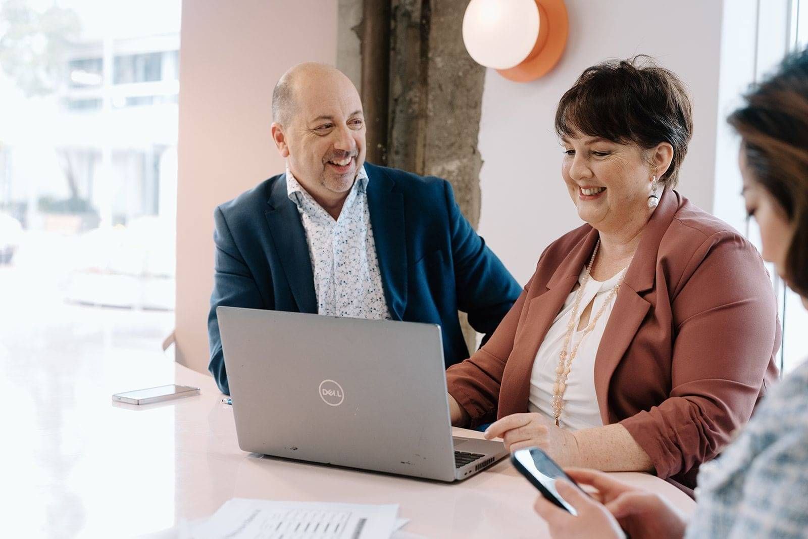 Neazor Brady advisers talking with a client at a laptop