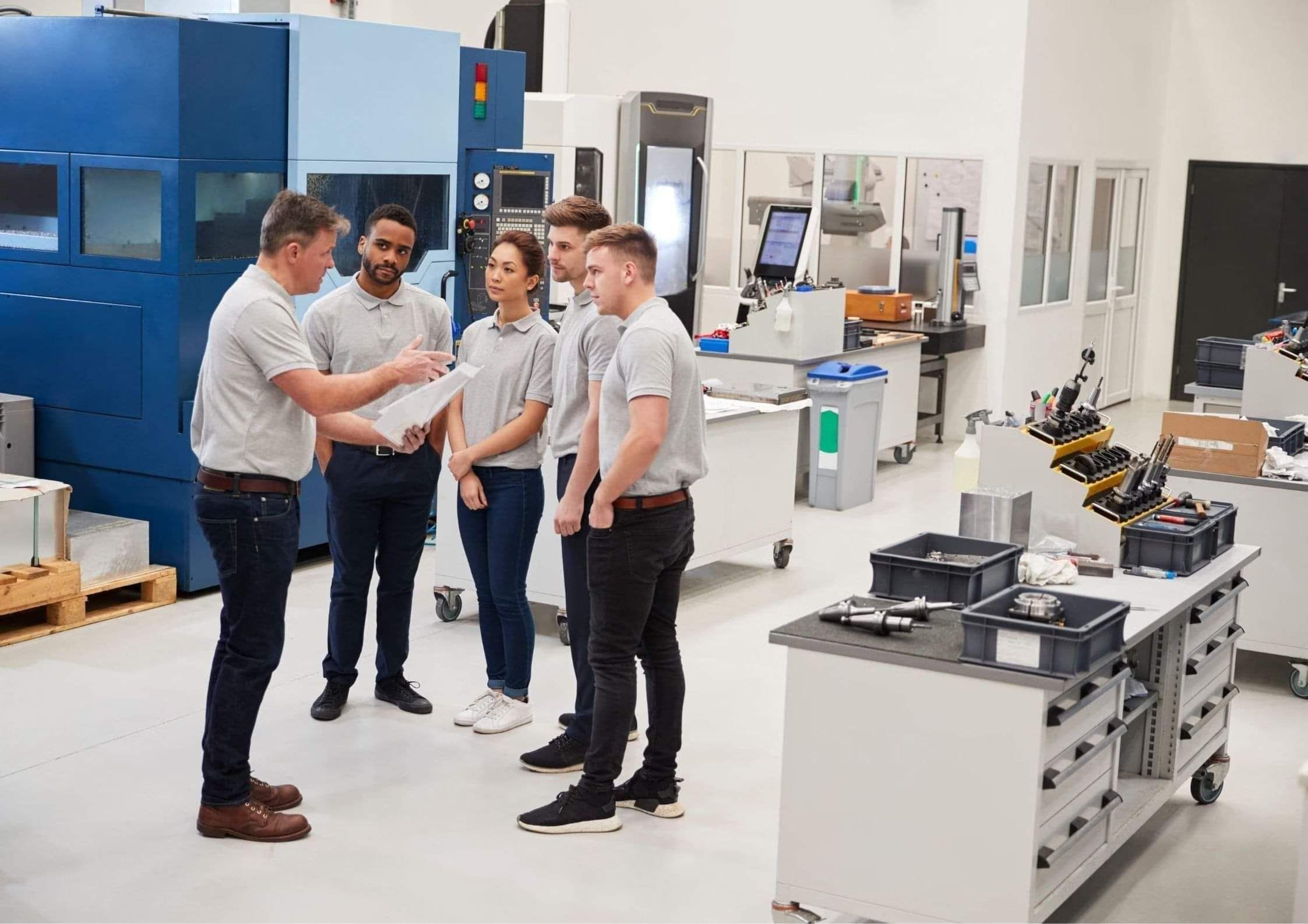 Team of colleagues talking in a manufacturing facility