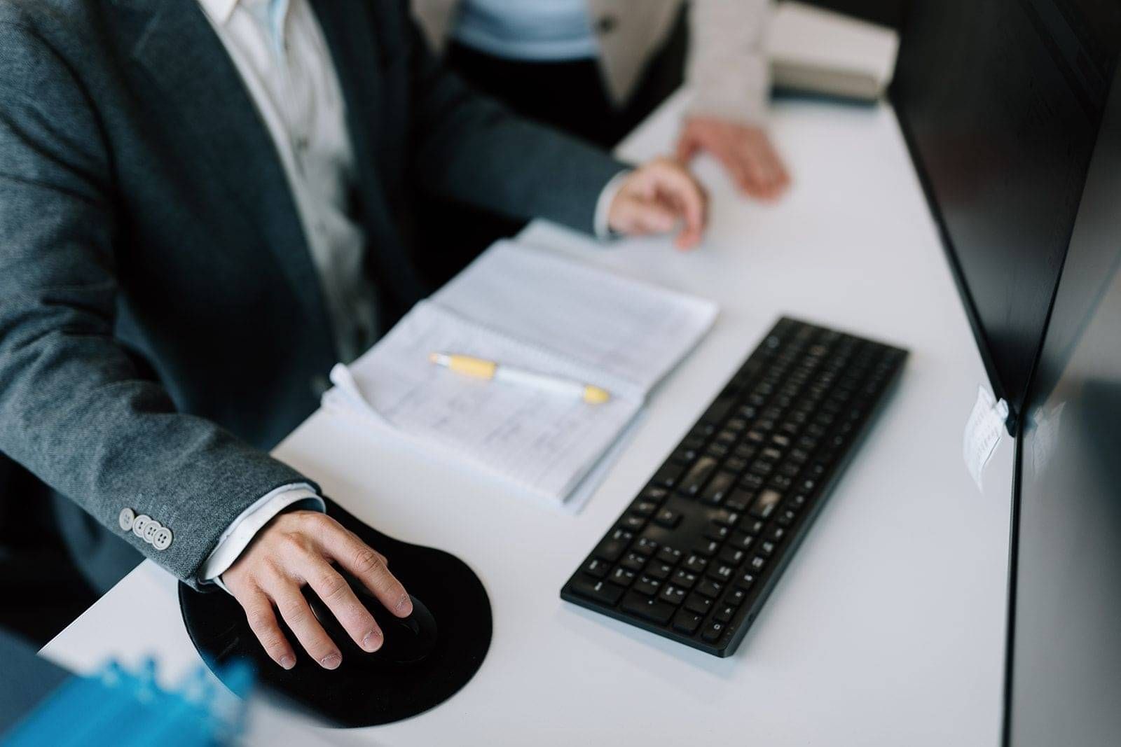 Adviser reviewing residence application documents at a desk