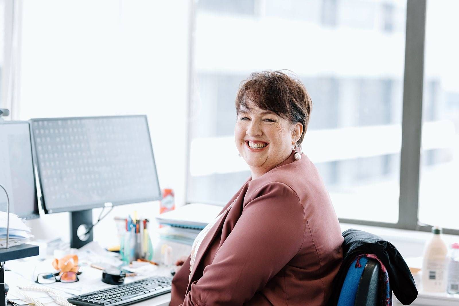 Catherine Neazor Brady at her desk, ready to take your enquiry