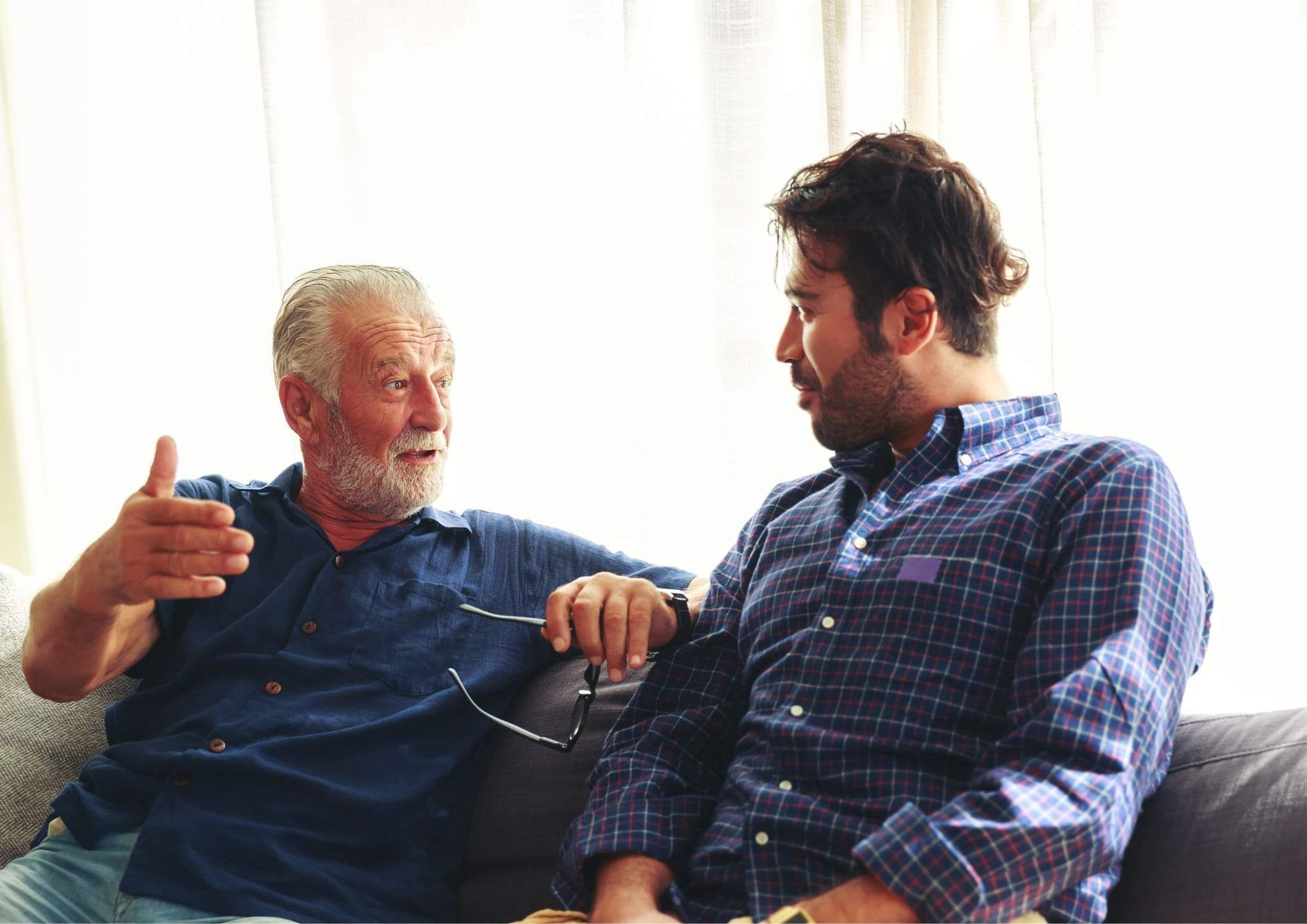 Father and son talking outdoors, one a New Zealand citizen by descent
