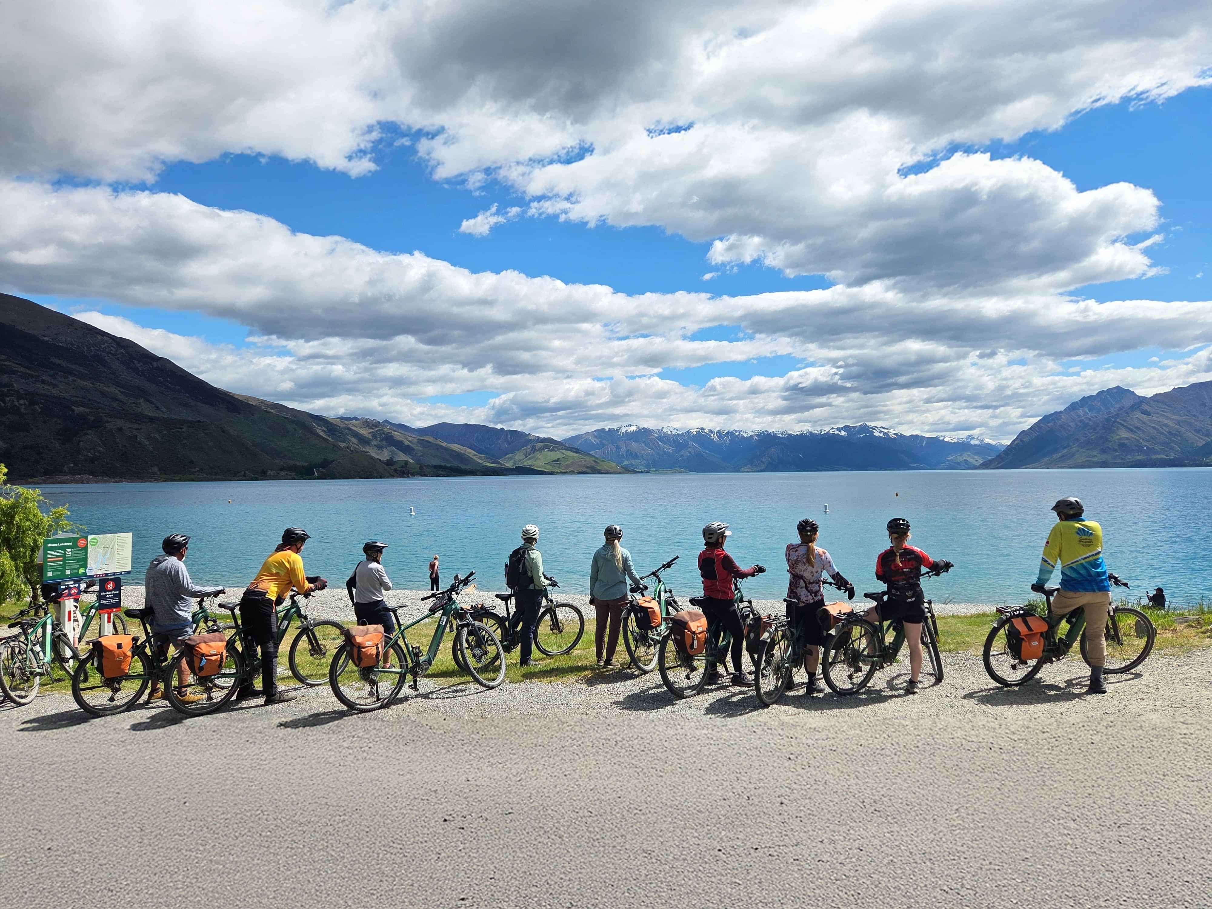 Riders look out across the lake with Pacific Cycle Tours in New Zealand