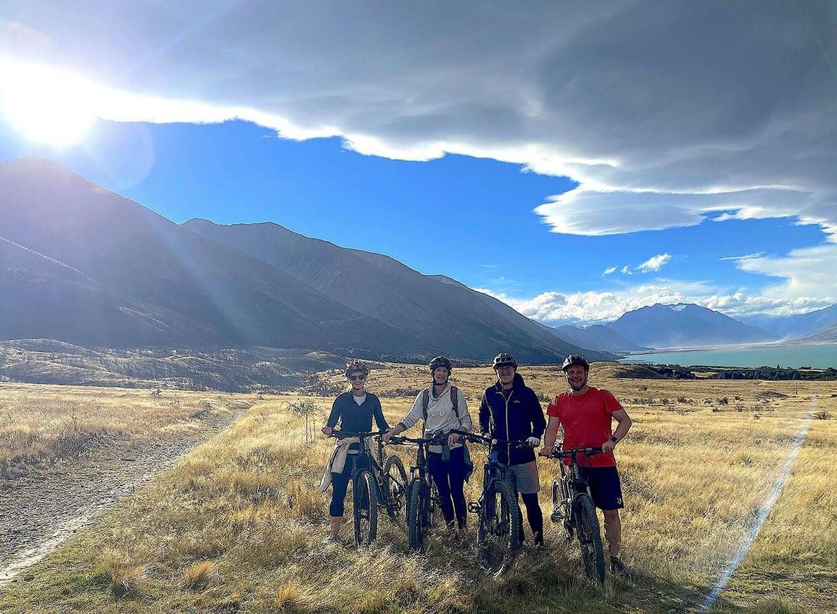 Posing for a photo with the alps in the background with Pacific Cycle Tours in New Zealand
