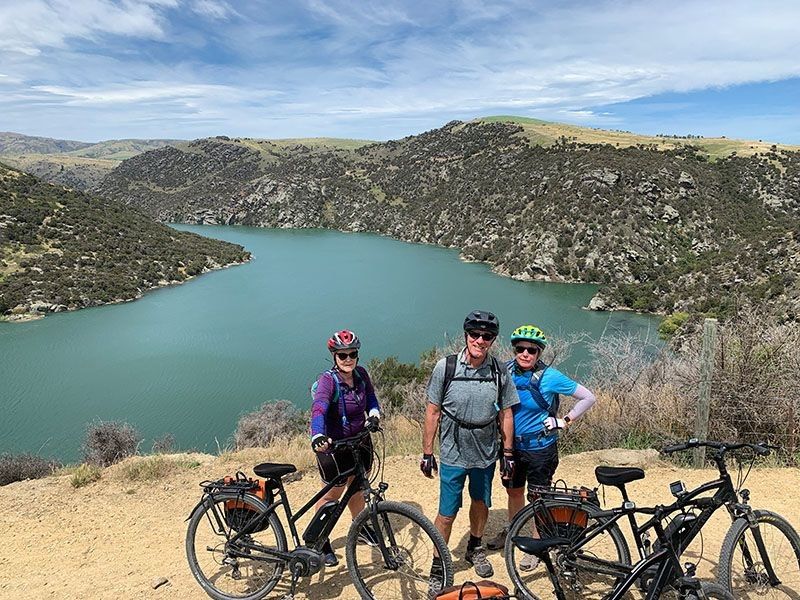 At the top of a hill posing for a photo on the trails with Pacific Cycle Tours New Zealand