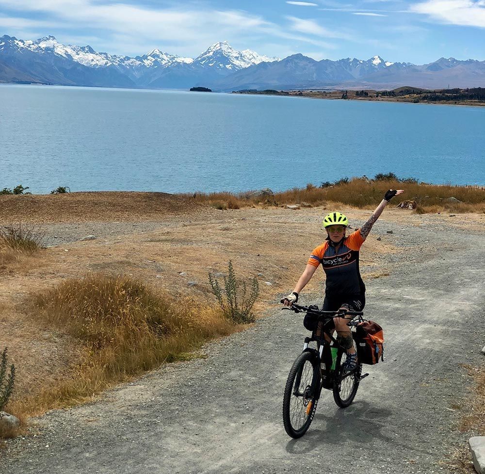 Waving at the camera while riding the Alps 2 Ocean · classic 7 day tour