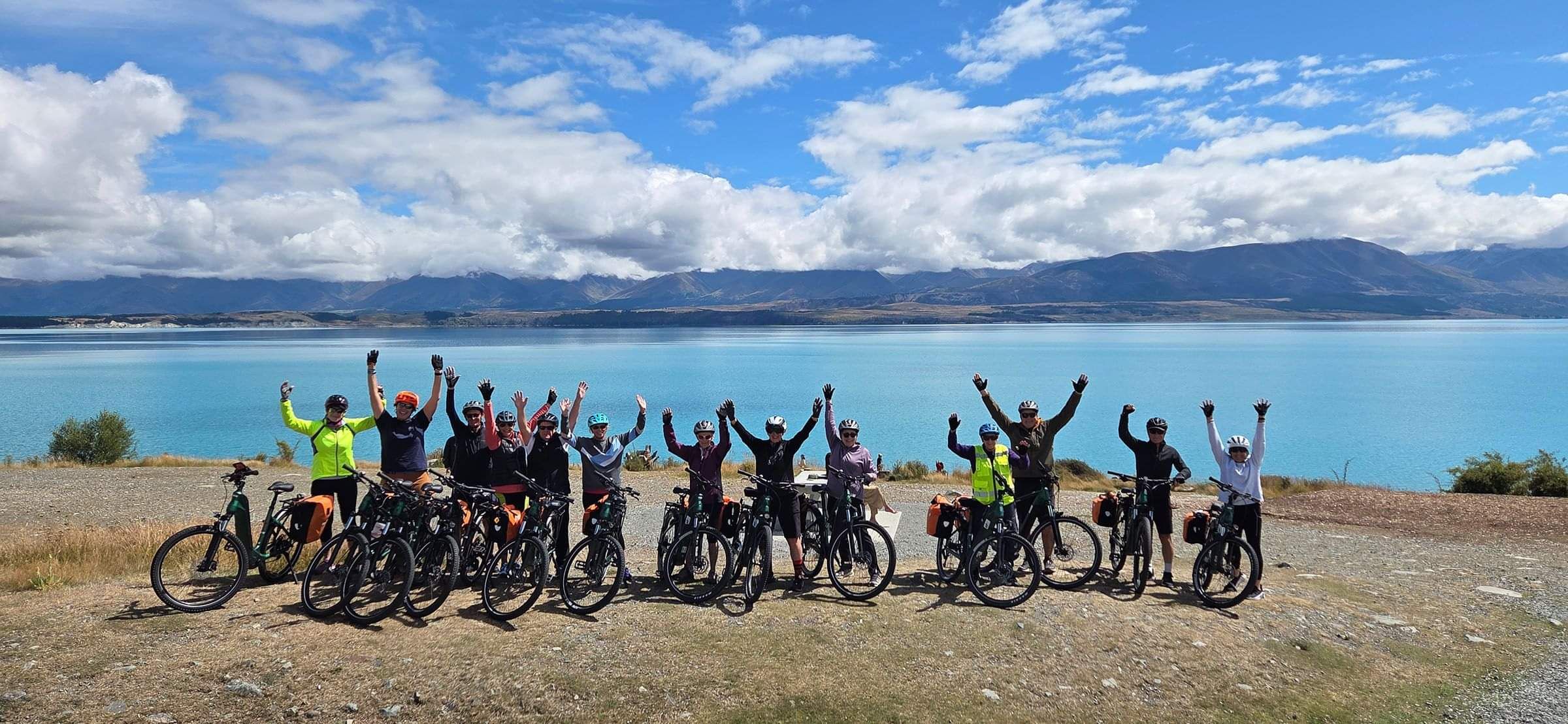 Group photo of a guided tour with their hands in the air