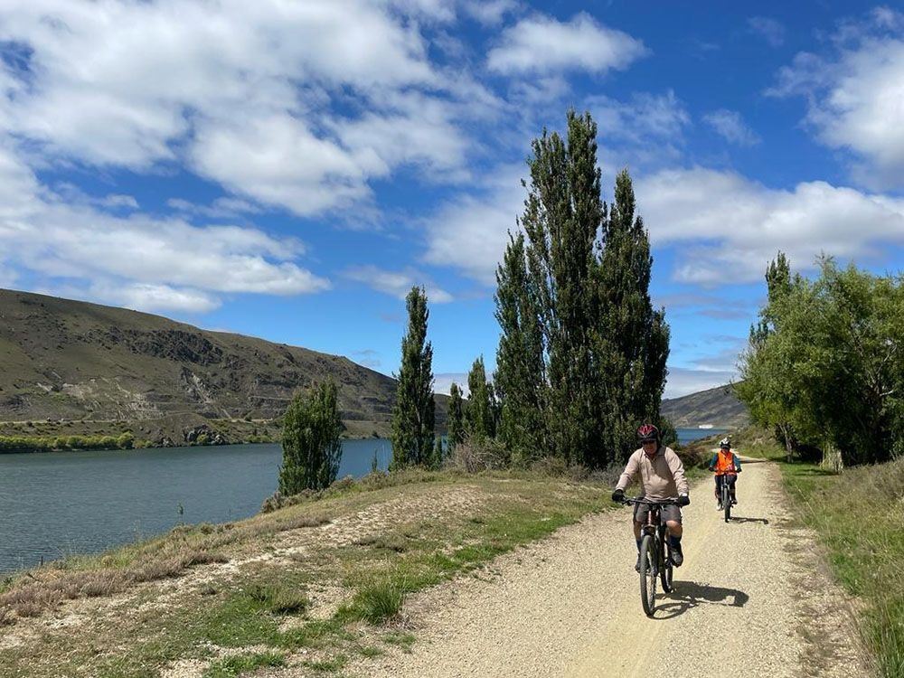 Riding next to the lake on the Queenstown & Central Otago Highlights tour