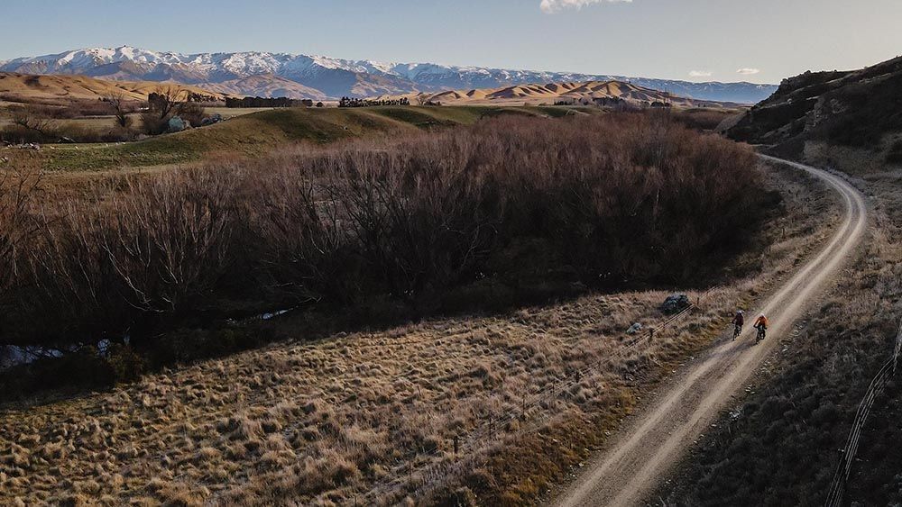 Riding the Otago Rail Trail wit the Southern Alps in the background