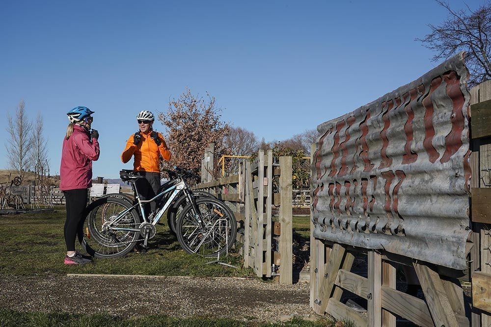Riders stop at a gate along the Otago Rail Trail