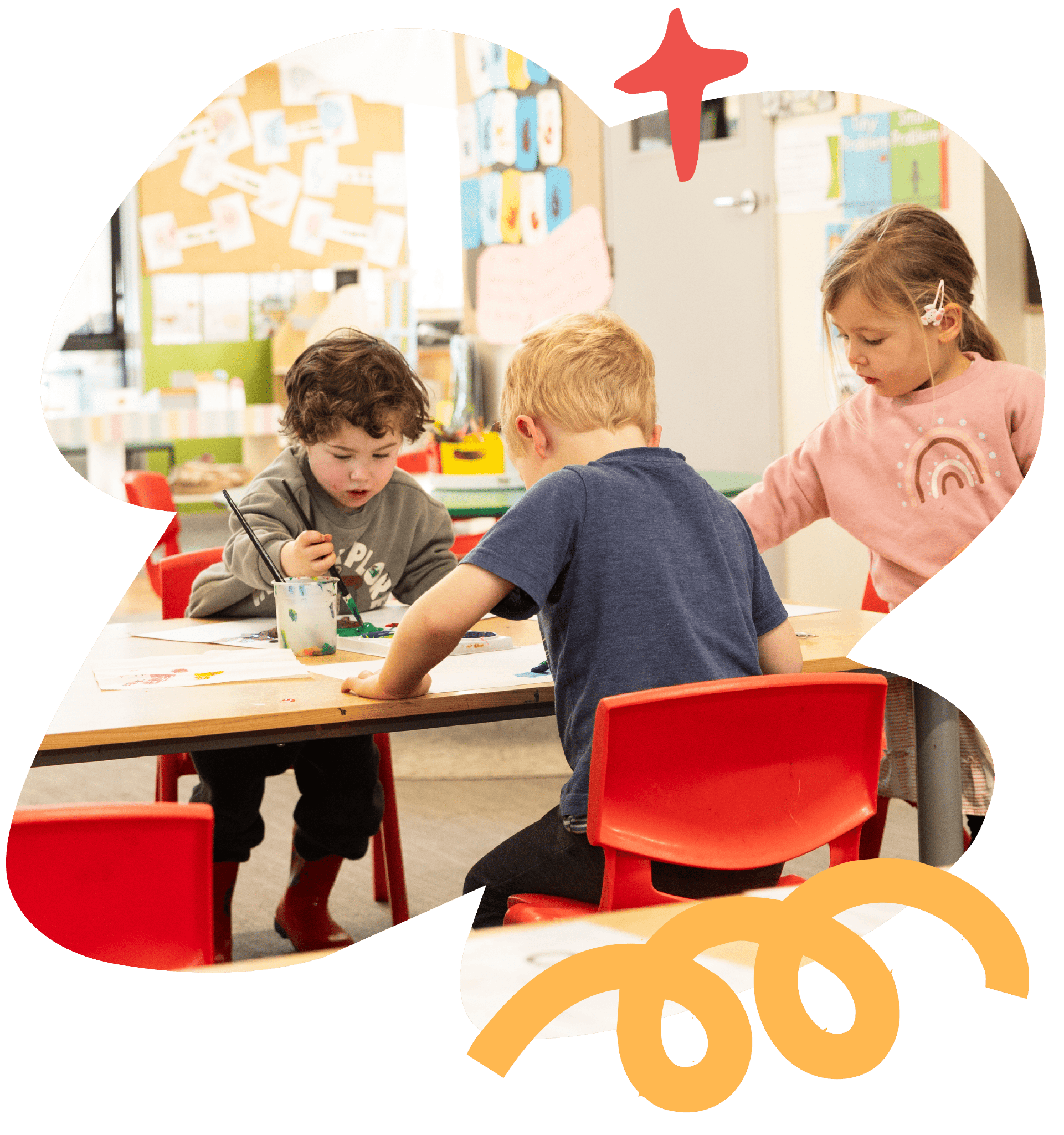 Children painting together in a Sunshine Childcare classroom.