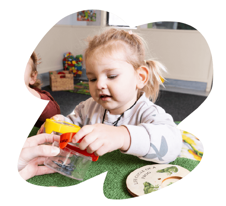 A toddler taking part in a guided learning activity at Sunshine on Sunshine.