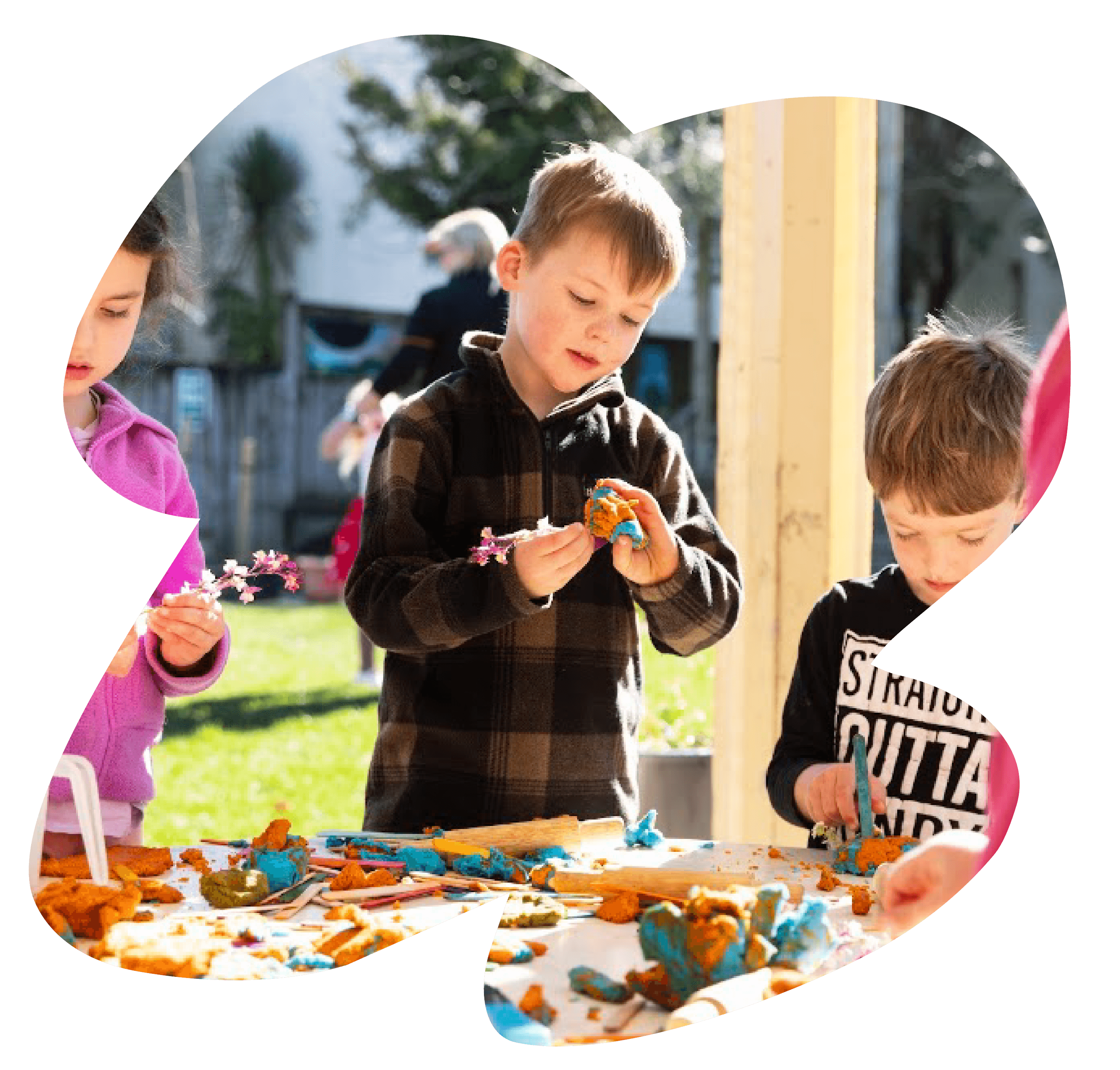 Children playing with playdough outdoors at Sunshine on Vickery.