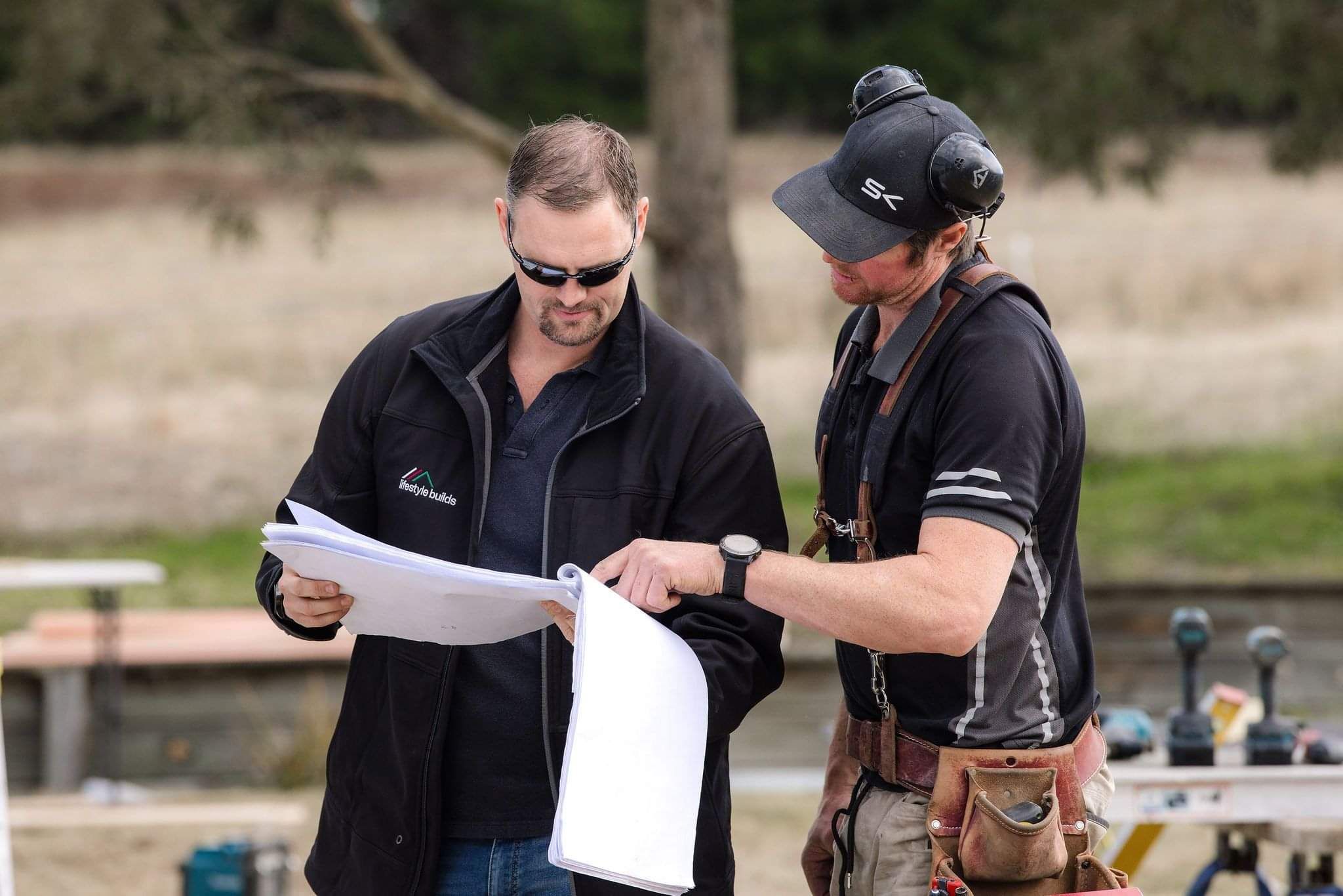 KJ and Ian reading the plans together on site