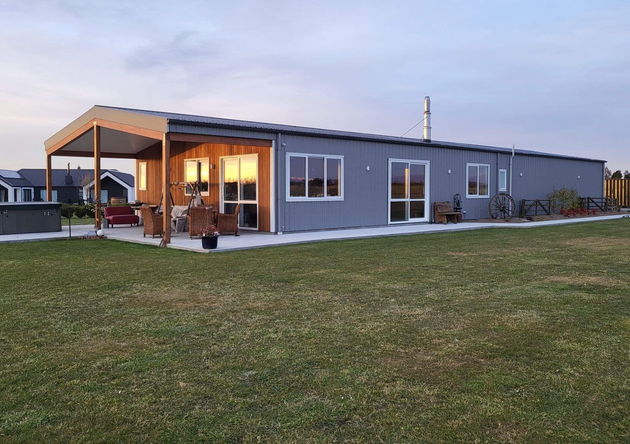 Custom Lucerne shed home in Methven with a covered gable porch and cedar cladding
