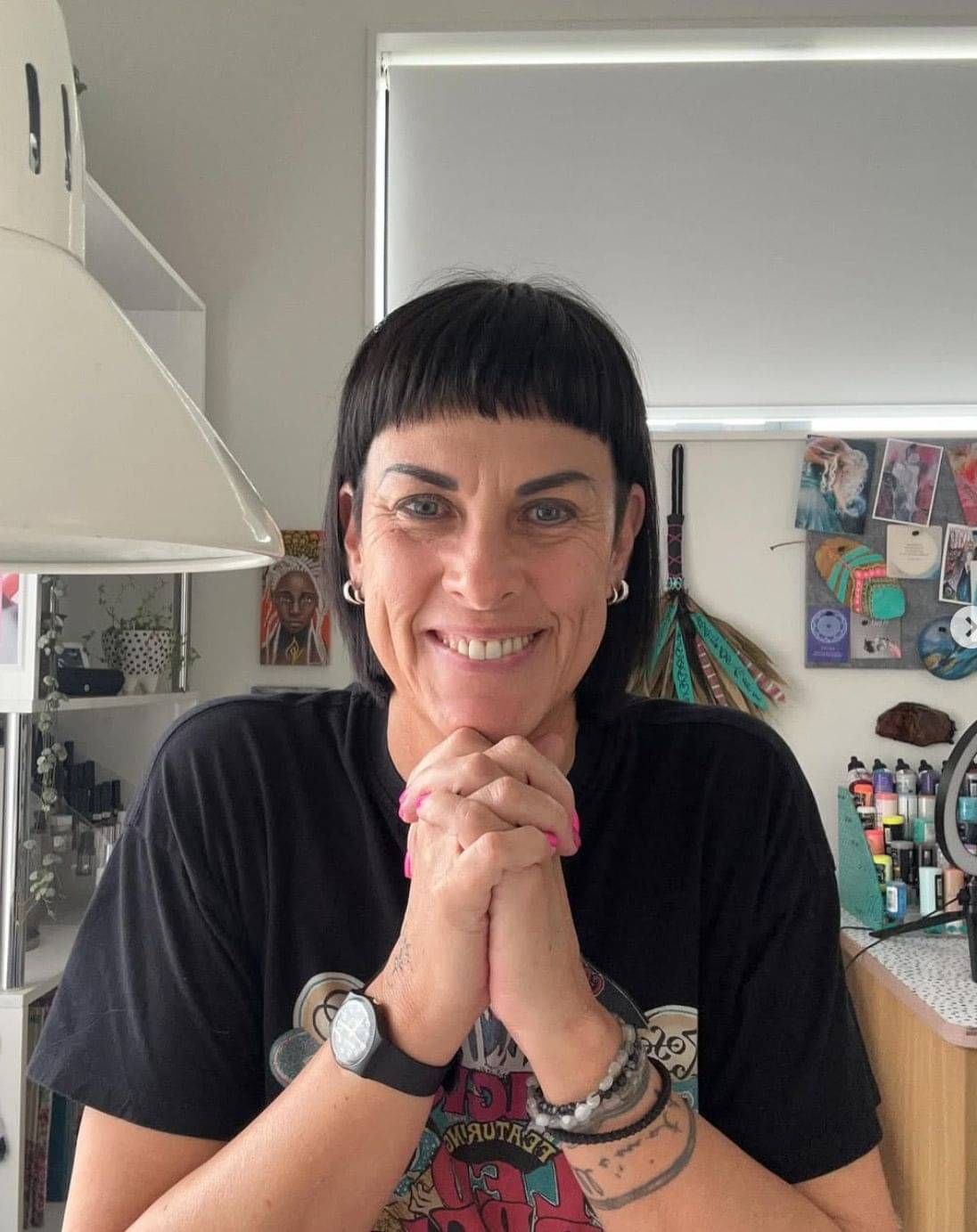 Adelien de Wet, owner of Just Nails in Greenhithe, smiling in her colourful home studio